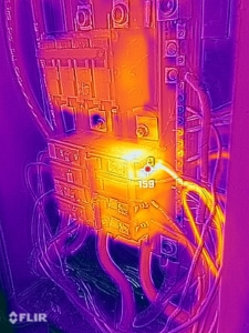 FLIR thermal image showing a hotspot on an electrical panel during an infrared home inspection